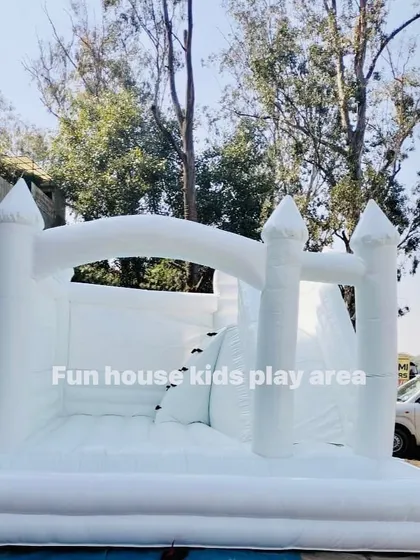 A clear, full shot of our 15x15 foot 4-in-1 white bouncy castle, showcasing its size and features before the party starts.