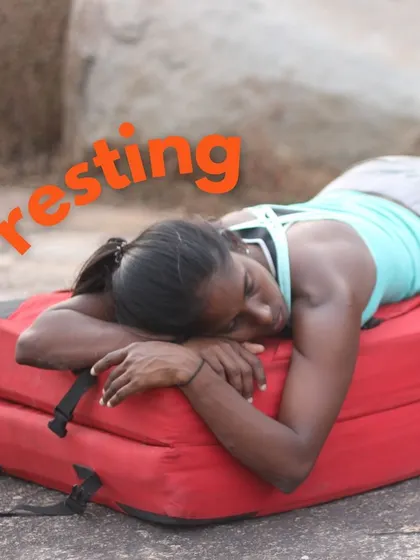 Rest is just as important as climbing. A climber takes a well-deserved nap on a crash pad between attempts. Our festivals are about listening to your body and finding balance.