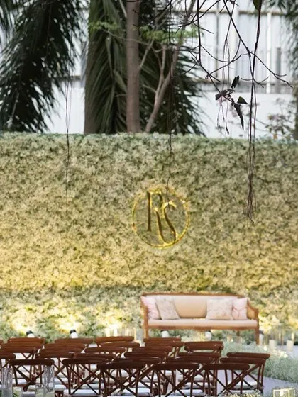 An ethereal all-white reception. The aisle and backdrop are adorned with clouds of baby's breath, while flickering candles cast a warm, romantic glow, creating a scene straight out of a fairy tale.