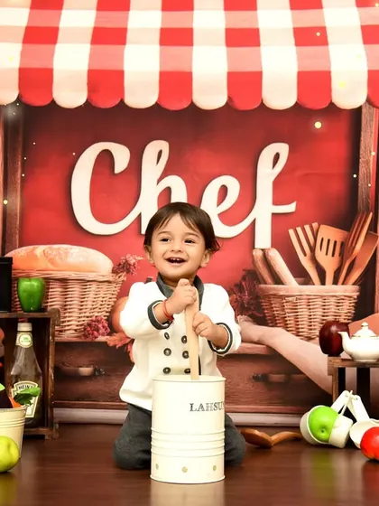 The master of his kitchen. This chef-themed portrait captures a moment of pure joy and imaginative play.