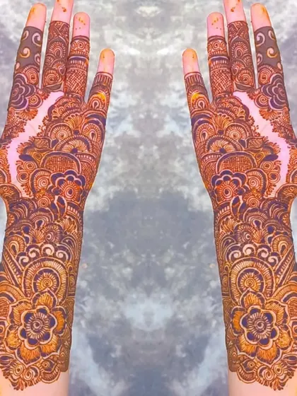 A stunning full-coverage design with a central floral pattern that flows into intricate details up the arm. The negative space in the middle creates a beautiful 'bail' effect within a heavy design.