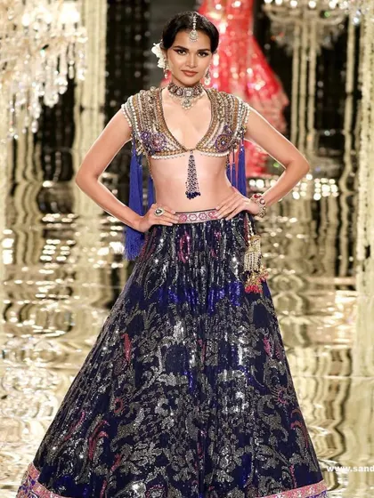 Another look from the Suneet Varma couture show. The makeup features a classic bridal feel with a modern twist, perfect for the heavily embellished lehenga.