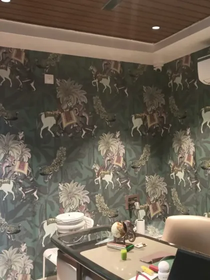 An intricate wallpaper depicting a royal Indian procession with elephants and horses, adding a touch of grandeur.