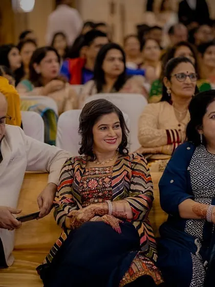 Capturing the audience. Family and friends watch the Sangeet performances with smiles and rapt attention.