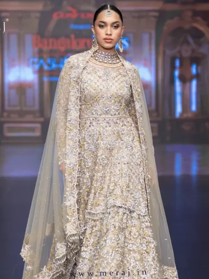 This Gold Tail Peplum Indo-Western outfit, straight from the fashion show, is designed for modern brides who want a regal and elegant wedding reception look.