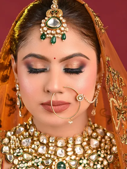 This image focuses on the eye makeup, showing a beautifully blended brown and gold smokey eye, a technique that is essential for every bridal artist.
