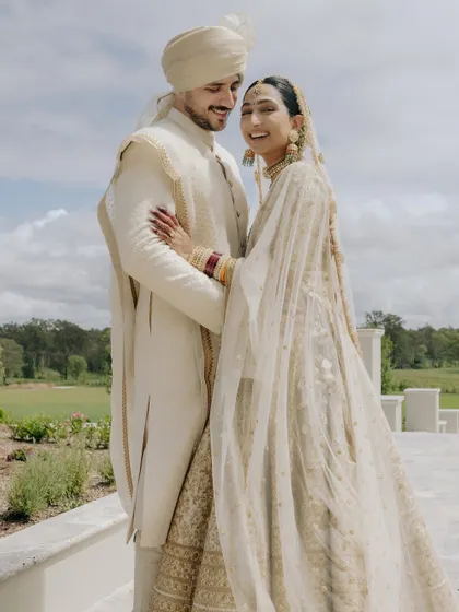 A warm and affectionate portrait of Manchal and Luca, their embrace full of love and laughter during their Australian wedding.