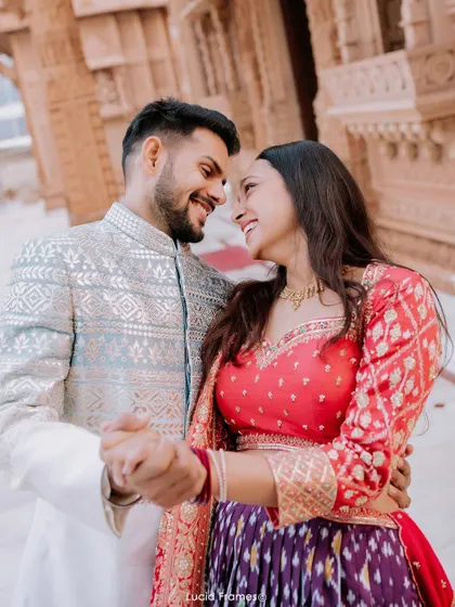 A candid moment of the couple dancing and smiling, showcasing their joyful connection.