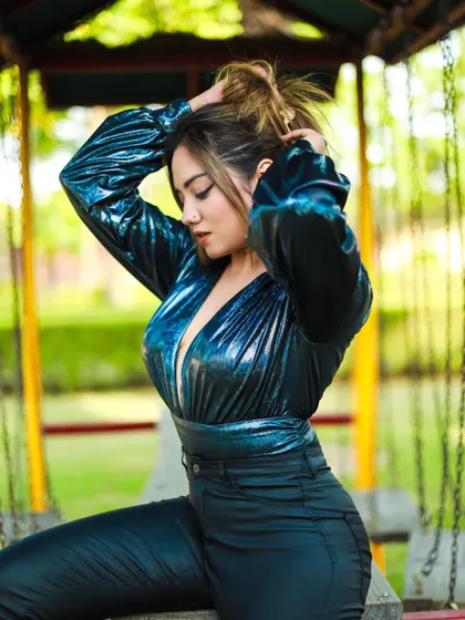 A candid-style shot of the model adjusting her hair, creating a sense of movement.