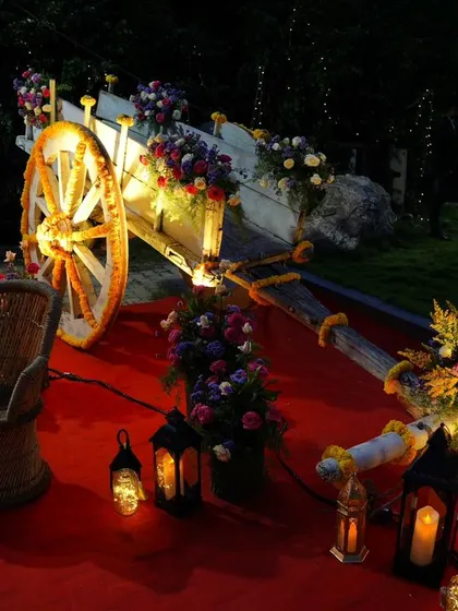 The decorated cart illuminated at night, creating a romantic and enchanting focal point for an evening wedding or reception.
