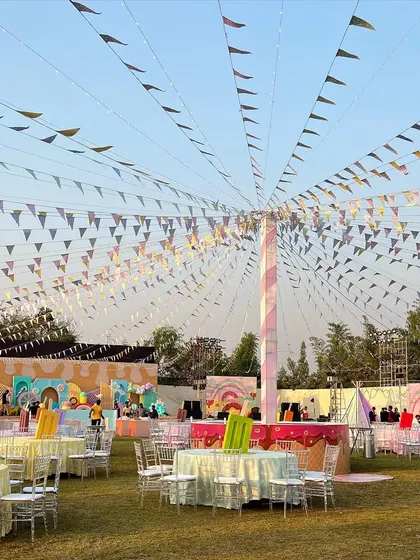 The full view of our Candyland theme, with colorful bunting creating a canopy over the entire lawn for a festive and fun-filled day.