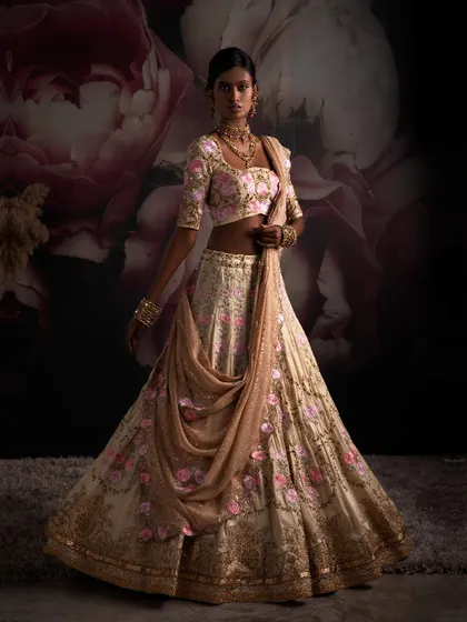I work to evoke enchantment with premium fabrics and mesmerizing designs. This bridal lehenga, with its floral embroidery and graceful drape, embodies the essence of Indian glamour.