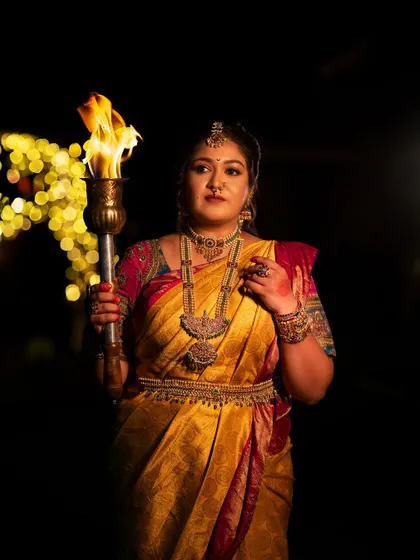Another powerful image from the "Navataar" series, with the torch illuminating the subject's determined expression against a backdrop of bokeh lights.