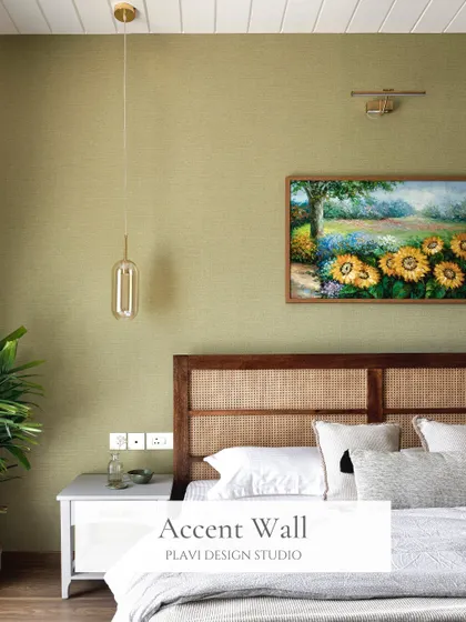 An accent wall is a great way to add personality to a bedroom. This olive green wall, paired with a rattan and wood headboard, creates an earthy and grounded focal point for the room.
