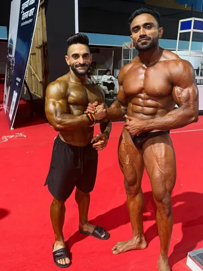 The brotherhood of iron. Shaking hands with a competitor backstage, showing mutual respect.
