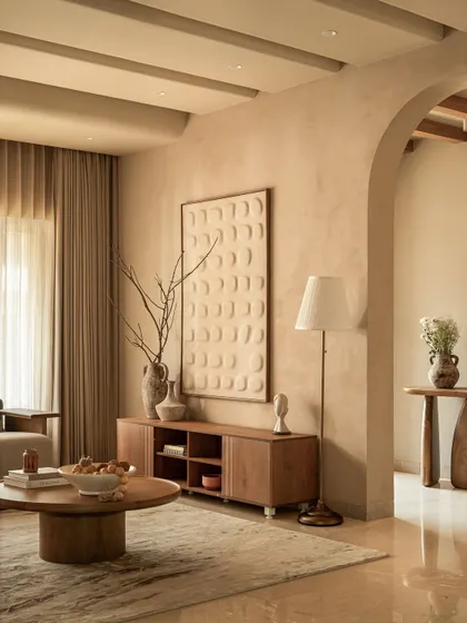 A closer look at the living room's meditation on texture. The clay-art inspired wall panel adds a sculptural dimension, grounded by a clean, low-slung media console in rich wood.