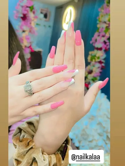 A playful and bold design combining solid bright pink nails with a classic white French tip on accent nails. This is a fun way to mix and match different styles.