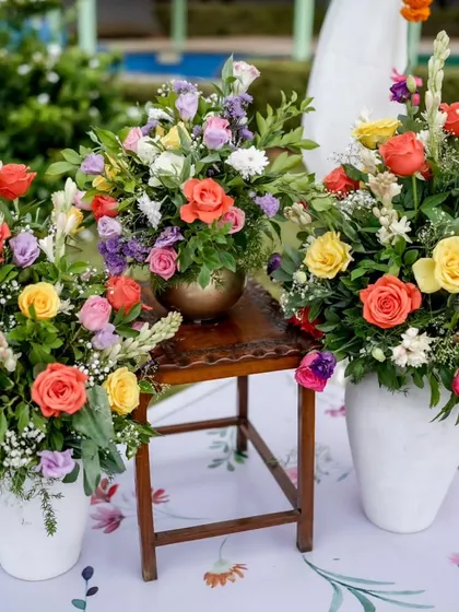 Vibrant floral arrangements in shades of yellow, orange, and pink, ready to brighten up a Haldi ceremony.