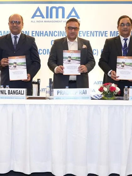 On the dais with fellow panelists at the AIMA program, holding the event literature. Collaboration is key to advancing legal understanding.
