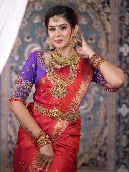 A beautiful bride showcasing a complete antique gold replica set. The layered necklaces and intricate choker are designed to make a grand statement for a traditional wedding ceremony.