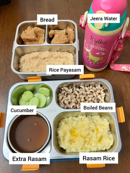 A comforting and simple South Indian meal for the lunchbox. This includes rasam rice with extra rasam for mixing, boiled beans for protein, cucumber for hydration, and rice payasam with bread for a sweet finish.