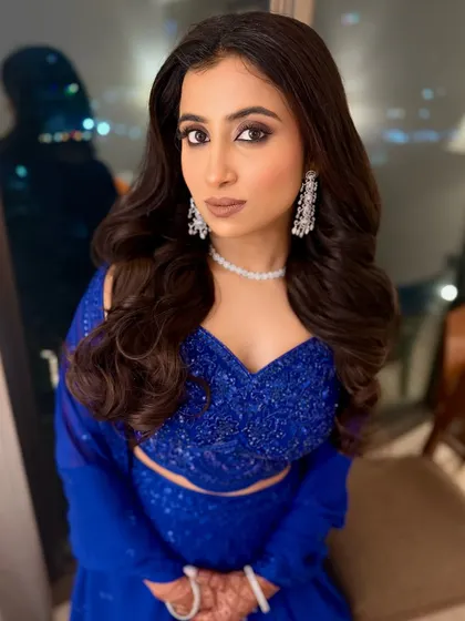 A dash of dazzle. I transformed her into a showstopper with this bold and stunning makeup look in a royal blue outfit. The smoky eyes and nude lips steal the spotlight.