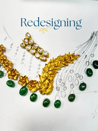 Redesigning the vision. This image shows our initial sketch for a statement necklace, with the actual gold pieces and loose gemstones laid out on top to finalize the design.
