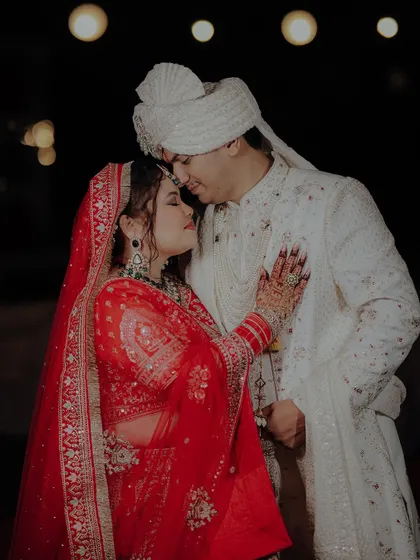 An intimate and romantic portrait of the bride and groom. The bride's hand on his chest, their foreheads touching, this shot is full of emotion.