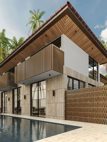 The poolside view of the contemporary Balinese-style villa in Goa. The design uses cantilevered balconies and large glass openings to create a lightweight structure that maximizes views and natural light.