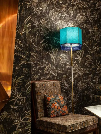 A cozy corner featuring our custom-designed furniture and wallpaper. It's these little details that make the space feel unique and thoughtfully curated.