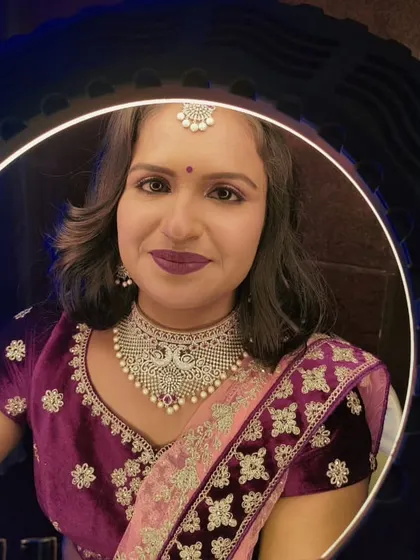 Lakshmi, ready for her reception. I created a bold look with a deep berry lip and defined eyes to match her royal velvet lehenga.