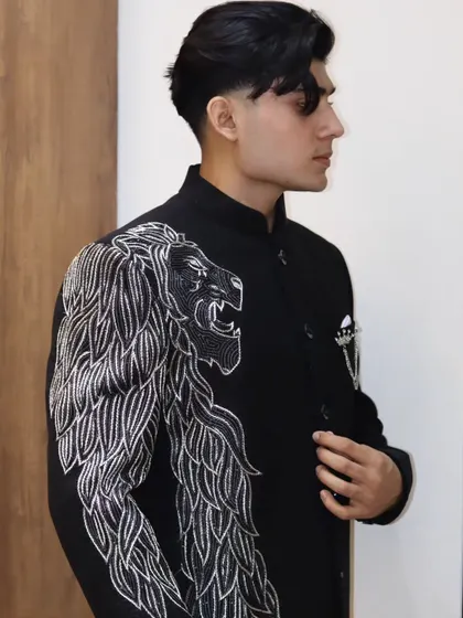 A side profile showcasing the sharp cut and fit of the lion bandhgala. The way the garment sits on the shoulder and chest is a testament to true bespoke tailoring.