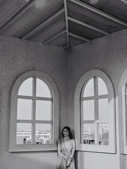 A solitary, reflective portrait of the bride in black and white, using the strong lines of the architecture to create a powerful and elegant image.