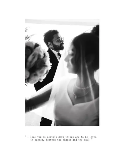 An artistic black and white photo capturing a soft, intimate moment between the bride and groom.