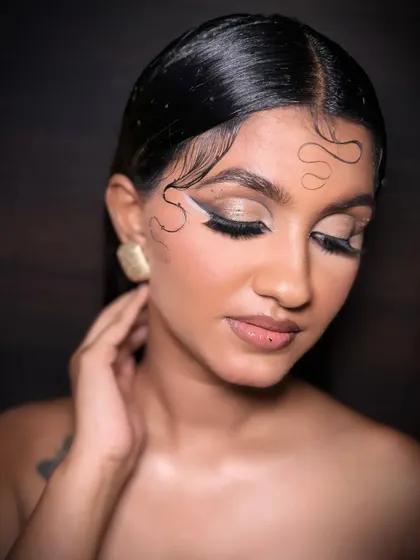 A beautiful shot of a model wearing an airbrush glam look with creative graphic liner. The flawless skin finish is a hallmark of airbrush makeup, a technique we cover in my pro courses.