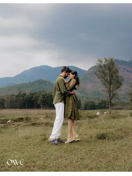 A stunning wide shot of a couple embracing against a backdrop of mountains, perfect for a cinematic save-the-date.