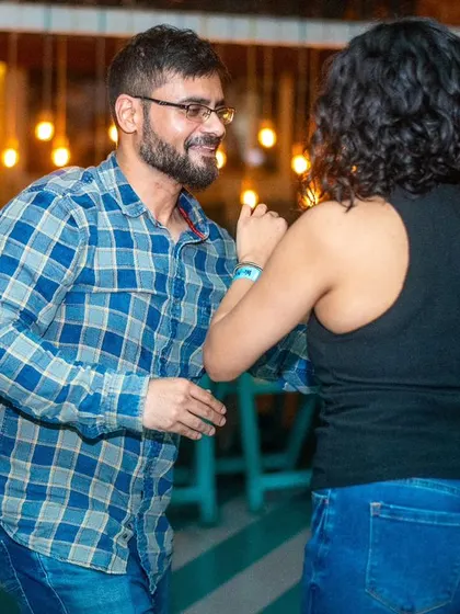 A focused pair moving together. The plaid shirt and jeans are a classic, casual dance look.