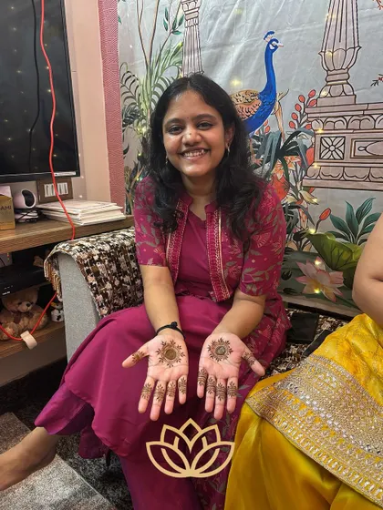 A happy guest showing off her simple and sweet mandala designs. Our goal is always to leave clients with a smile.