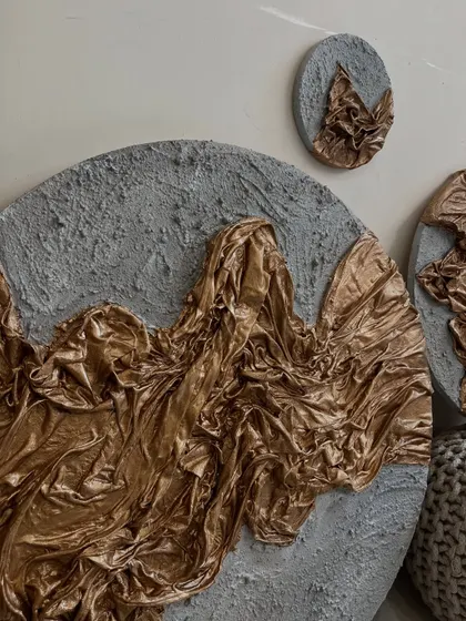An angled view of the gold and grey textured set, highlighting the 3D quality of the sculpted fabric.