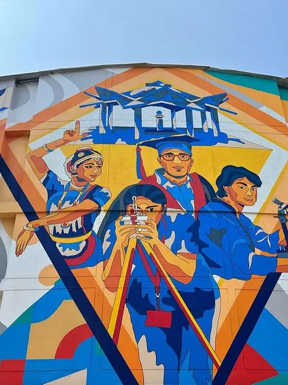 A close-up of the central figures in our mural for MVJ College of Engineering. The artwork celebrates different facets of engineering and college life, rendered in a bold, graphic style.