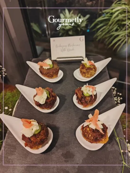 Gochujang Mushrooms with Yuzu, served on individual white spoons. This appetizer showcases our flair for creating unique Asian-inspired bites.