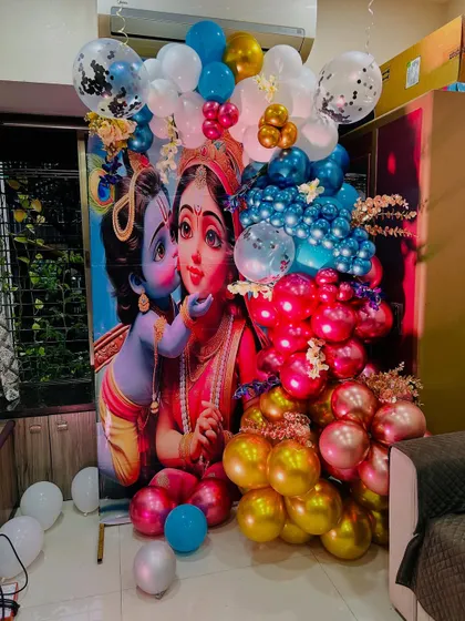 A closer look at the vibrant balloon arch and backdrop for a Krishna themed naming ceremony. We use a mix of metallic, chrome, and confetti balloons in multiple colors to create a rich and textured photo corner.