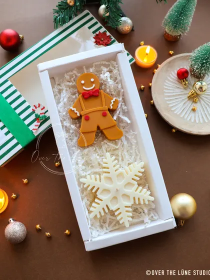 Confused about what to gift for Christmas? My curated gift boxes are the perfect solution. This one features a gingerbread man and a snowflake candle in a festive striped box.
