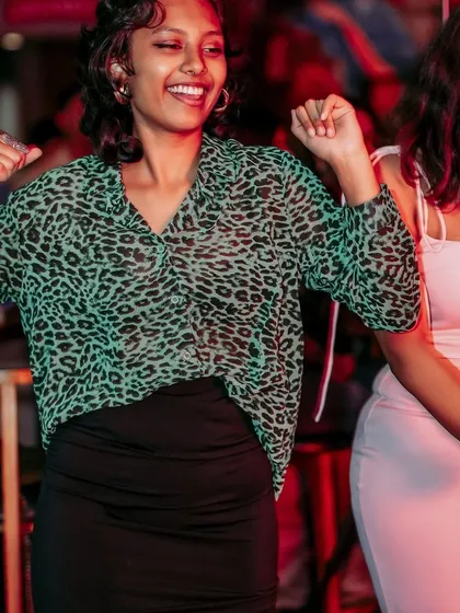 Pure happiness on the dance floor. This guest's infectious smile and energy perfectly capture the spirit of an Afrodisiac party.