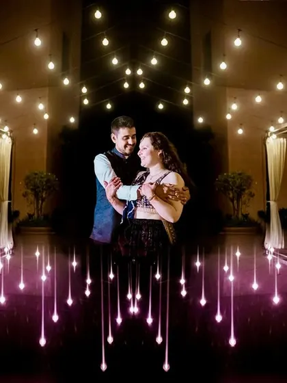 A creative portrait using reflections and lights. The couple appears to be floating in a "sky full of stars," a magical and unique engagement shot.