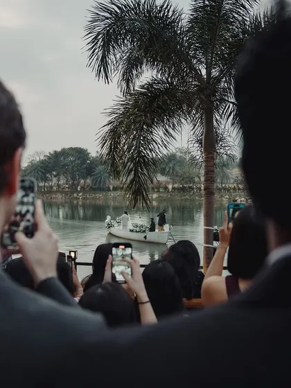 The guests' perspective of a magical moment. Everyone captures the bride and groom's romantic boat ride, a unique experience we planned for Sudhira and Prajwal's wedding.