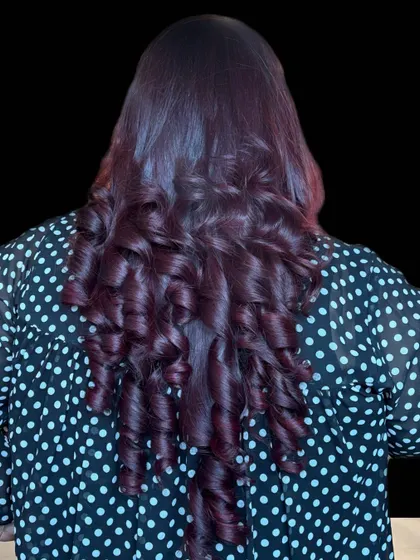 A beautiful example of a deep plum hair colour styled into perfect barrel curls. This shade is unique and looks stunning, especially on long, healthy hair.