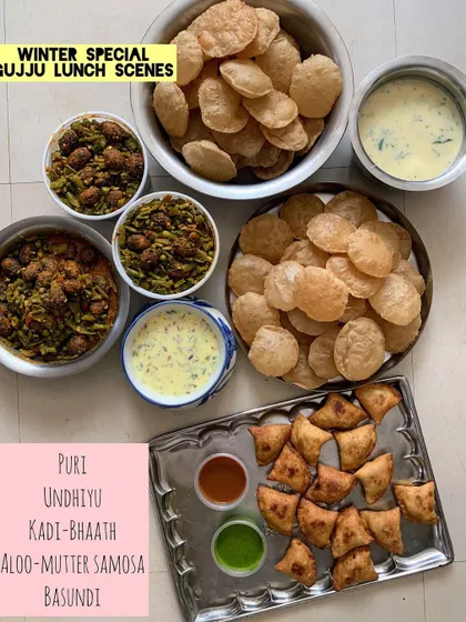 A comforting winter special Gujarati lunch. This traditional meal features authentic Undhiyu, soft Puris, Kadhi-Bhaath, Aloo-Mutter Samosas, and creamy Basundi, bringing the taste of home to your special occasions.