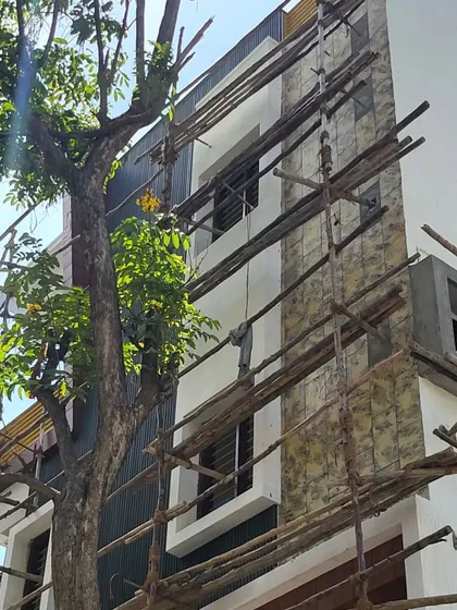 A closer look at the elevation work in progress. You can see the stone cladding being applied next to the dark-painted sections, slowly bringing the design to life.