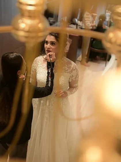A creative shot of me doing final touch-ups on the bride's lips.